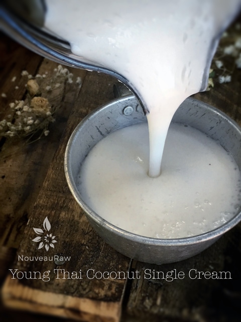 pouring raw vegan young Thai coconut single cream into a bowl