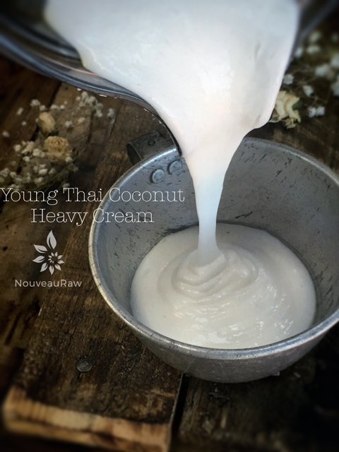 pouring young Thai coconut heavy cream into a tin cup