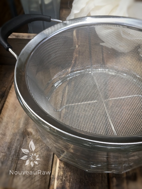 place a mesh strainer in a glass bowl