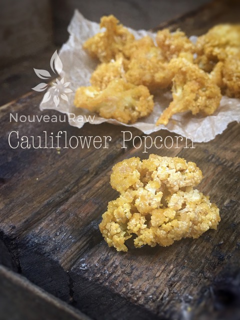 raw vegan Cauliflower Popcorn displayed on a wooden table