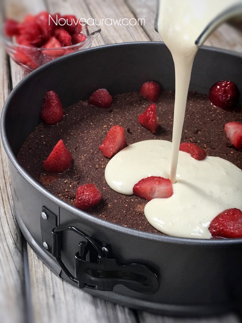 the crust is pressed into the pan with fresh strawberries being added 