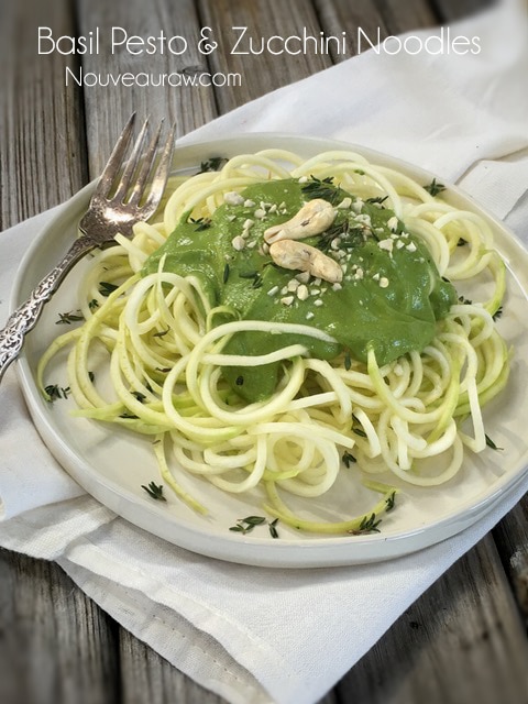 raw vegan Basil Pesto and Zucchini Noodles dished up on a white plate