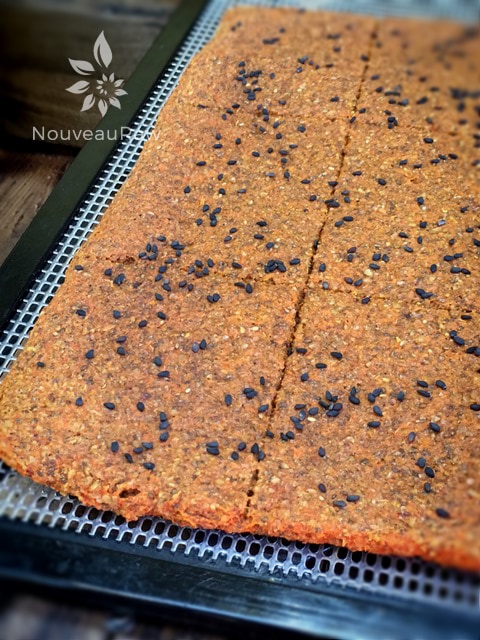 Cajun Breads Pieces with Black Sesames on dehydrator tray