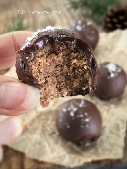 a close up of raw vegan gluten free delicious Chocolate Coconut Bombs displayed on parchment paper