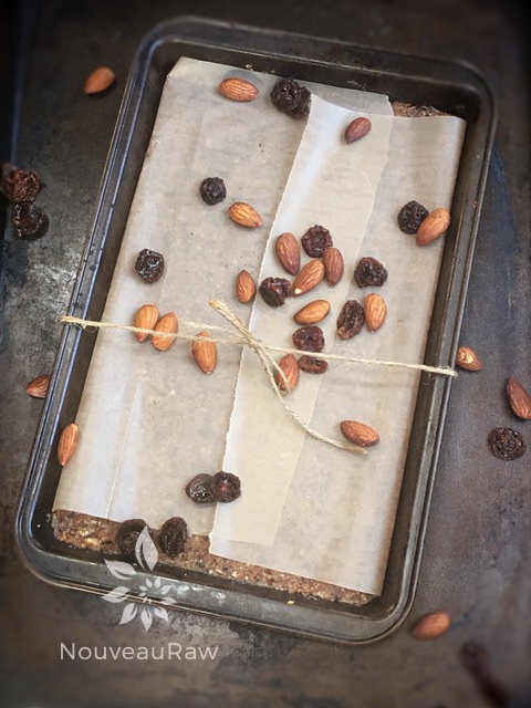 fig and cherry bars displayed with almonds and dried cherries