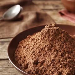 cacao-powder piled in a wooden bowl