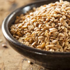 closeup flax seeds in a wooden bowl