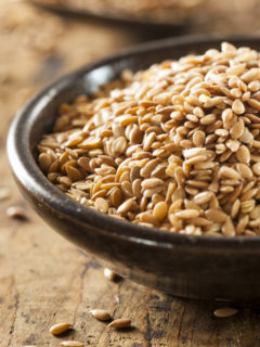 closeup flax seeds in a wooden bowl