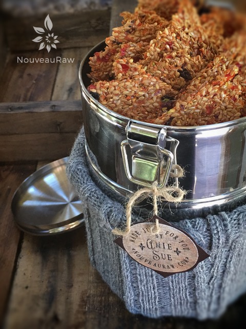 a close up of raw vegan gluten free Veggie Flax Crackers in a 3 tier tin