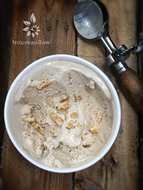 scooping out raw dairy free Maple Walnut Ice Cream from a tub