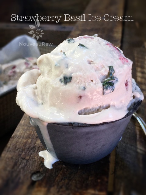 a close up of raw dairy free Strawberry Basil Ice Cream displayed on barn wood