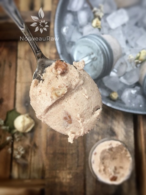 a close up of raw dairy-free Butter Pecan Ice Cream frozen in mason jars and placed in a tin of ice