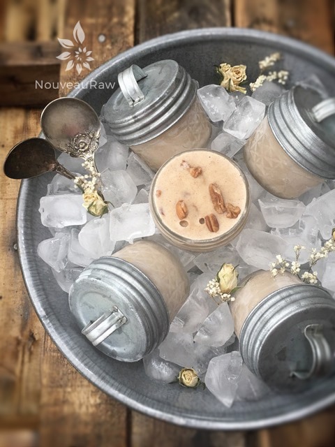 raw dairy-free Butter Pecan Ice Cream frozen in mason jars and placed in a tin of ice