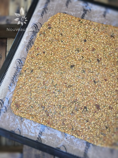 Let's start with the simplest way to make crackers. One big sheet! Spread thin and dehydrator. Flax crackers can be a challenge to score into shapes. If you miss the opportunity to do so... just break into pieces and serve them "rustic" style. Which is the in-thing these days.