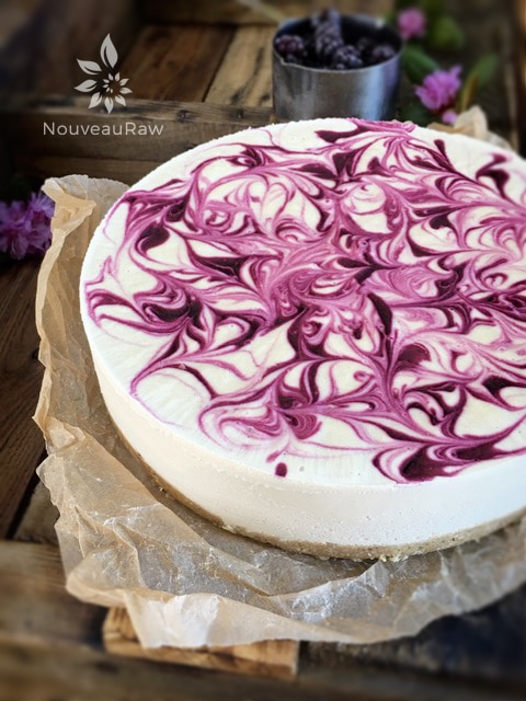 raw vegan blackberry lemon cheesecake presented on a wooden table
