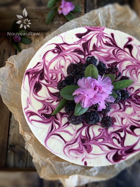 an over view of raw vegan blackberry lemon cheesecake presented on a wooden table