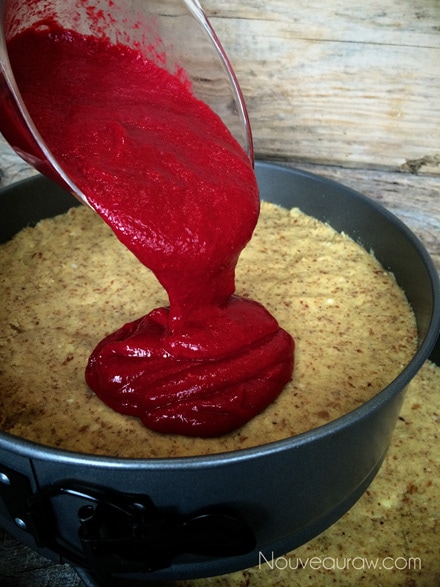 In one pan, pour half of the delicious raspberry filling on top of the cake