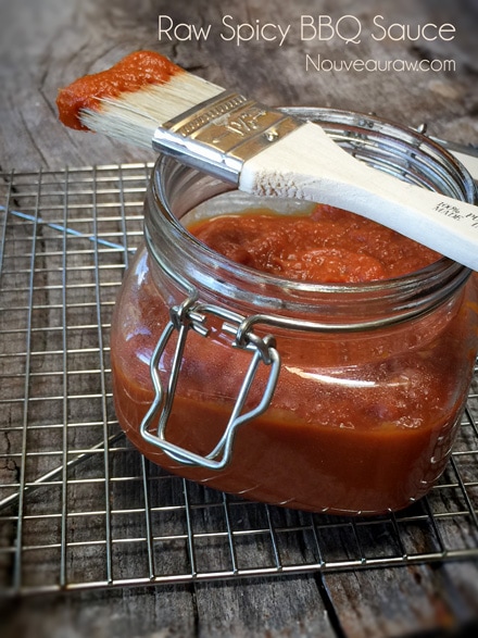 Spicy BBQ Sauce displayed on a wooden table with a brush used to brush the sauce on