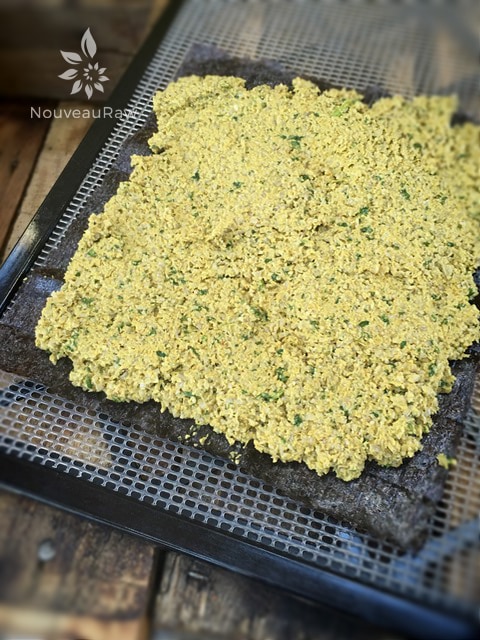 Lay the nori sheet on the dehydrator sheet, shiny side down. Add 1 cup of filling and gently spread it to about 1/4" from the edges.