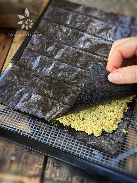 Lay another sheet or nori on stop. Cover with plastic wraps and gently roll the cracker flat, turning it and rolling out to each edge. Pop in the dehydrator.