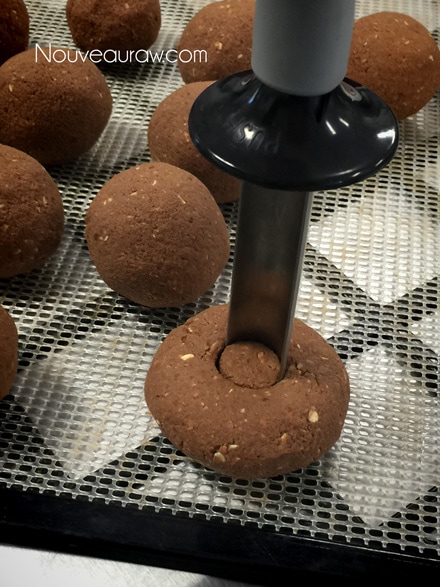 forming the raw vegan gluten-free Double Chocolate Cake Doughnuts using an apple corer