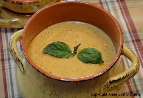raw vegan Spicy Broccoli Cheese Soup in a yellow rustic pot