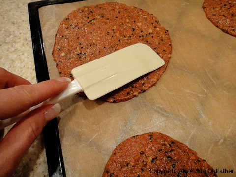 spreading the batter on dehydrator trays when making raw vegan gluten-free Sun-Dried Tomato and Sesame Wraps stacked
