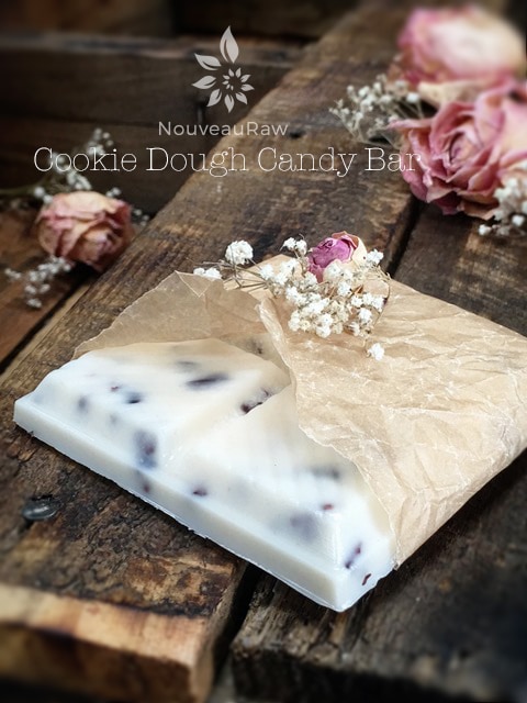 Cookie Dough Candy Bar displayed on a wooden table with dried roses