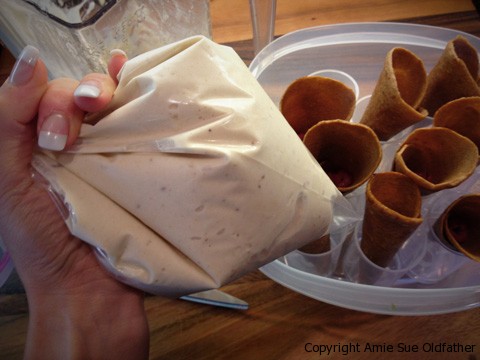 Here are the pureed frozen bananas in a Zip-lock bag ready to pipe into the cones.  Worked great.