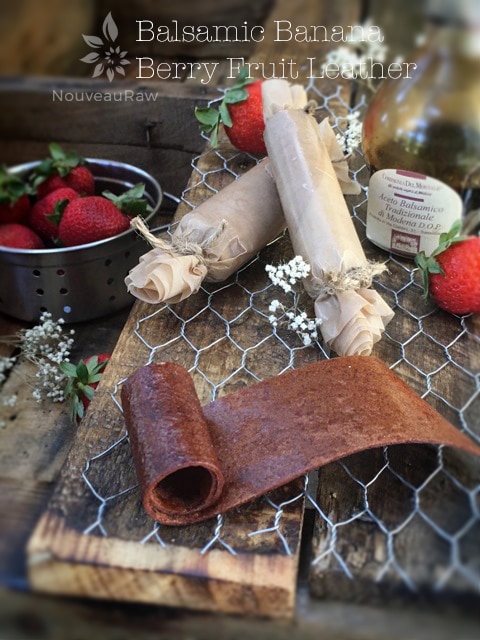 balsamic fruit leather rolled up and displayed on barn wood