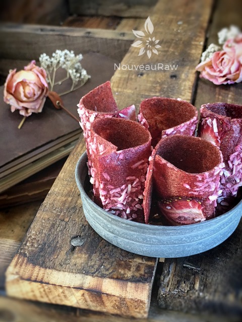 raw Banana Strawberry Coconut Fruit Leather rolled up and displayed in a zinc jar lid
