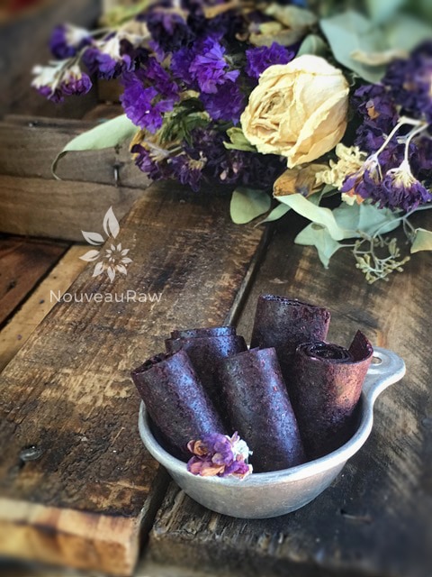 a beautiful display of raw Blackberry Almond Honey Fruit Leather on a barn wood table