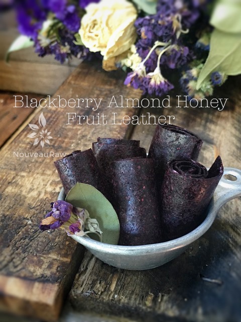 a beautiful display of raw Blackberry Almond Honey Fruit Leather and dried flowers