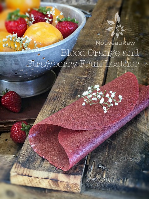 Blood Orange and Strawberry Fruit Leather displayed with fresh fruit on a table