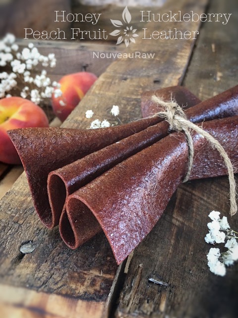Honey Huckleberry Peach Fruit Leather folded up and displayed on barn wood