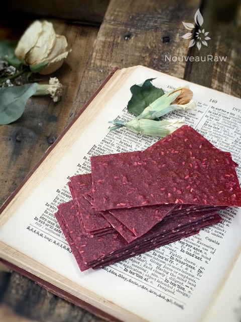 raw sugar free sweet and tart Sassy Raspberry Banana Fruit Leathers displayed on an antique dictionary