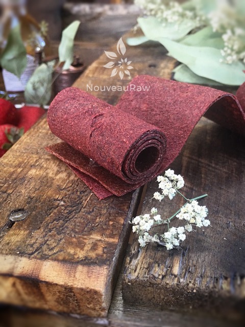 Strawberry Balsamic Black Pepper Fruit Leather shown on barn wood along with babiesbreath