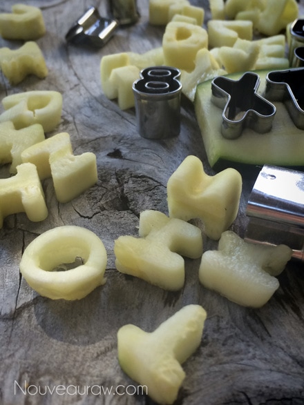 side view of creating zucchini letters with cookie cutters