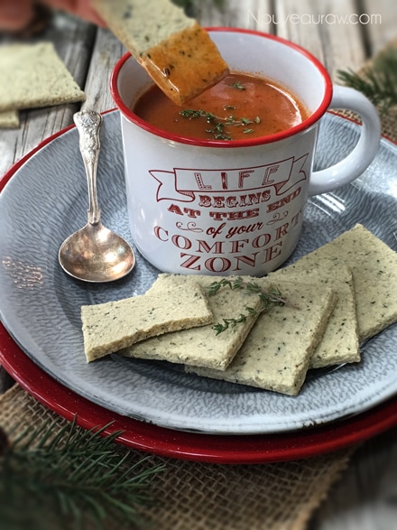 raw vegan gluten free Club Crackers being dipped into a mug of soup
