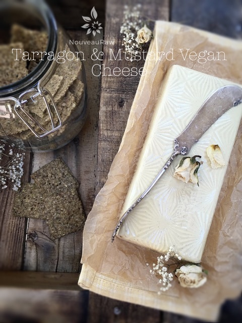 vegan Tarragon & Mustard Vegan Cheese served with raw crackers on barn wood table