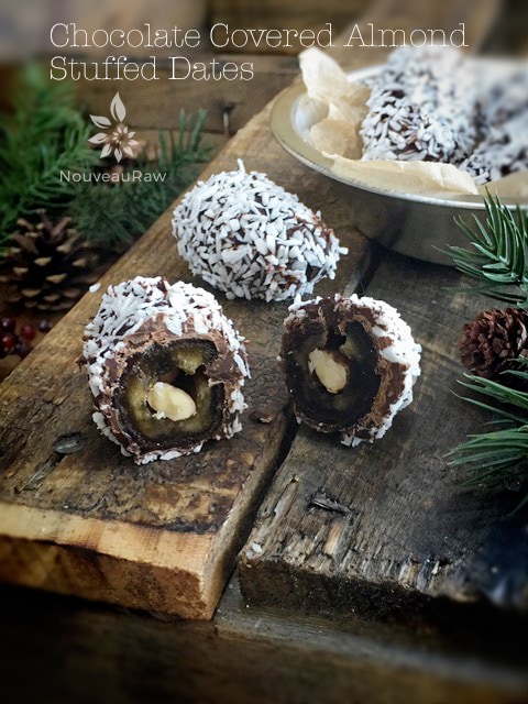 raw vegan Chocolate Covered Almond Stuffed Dates displayed on barn wood