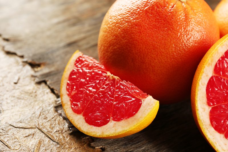 grapefruit-cut-in-half-on-wooden-table