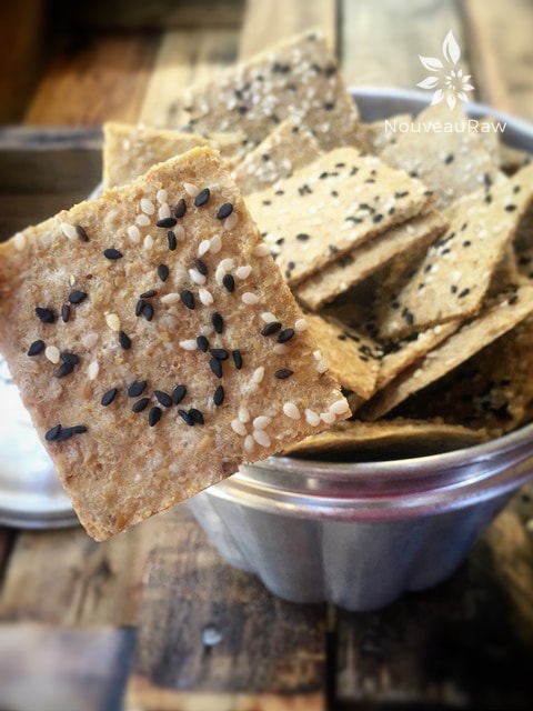a close up of raw gluten free Caramelized Onion Crackers displayed on a wooden table