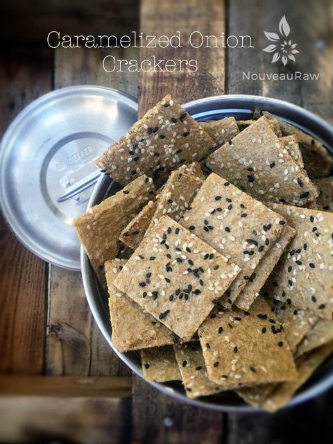 raw gluten free Caramelized Onion Crackers displayed on a wooden table