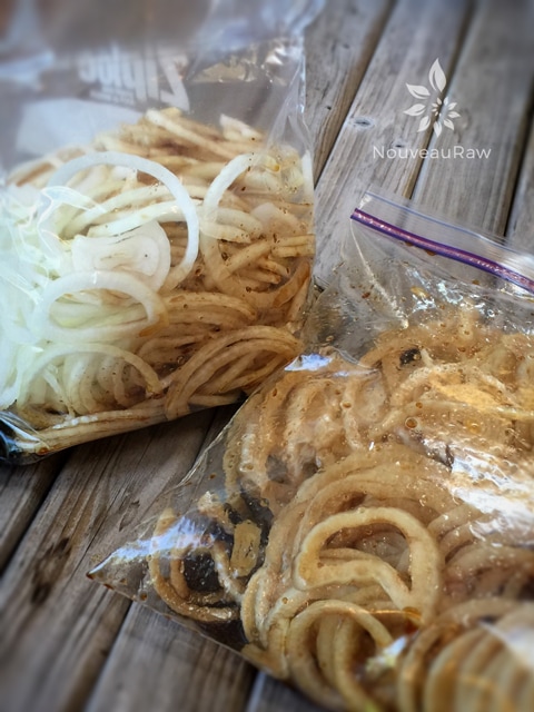 placing the raw caramelized onions in the dehydrator, using ziplock bags