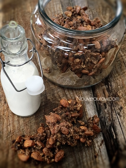 a close up of Almond Banana Nut Clusters displayed on barn wood and served with raw almond milk