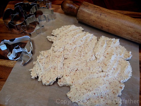 rolling out the dough to placing the dough to make dusting the counter surface to make raw vegan gluten free Animal Crackers