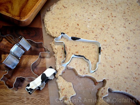 creating animal shapes with cookie cutters to make raw vegan gluten free Animal Crackers