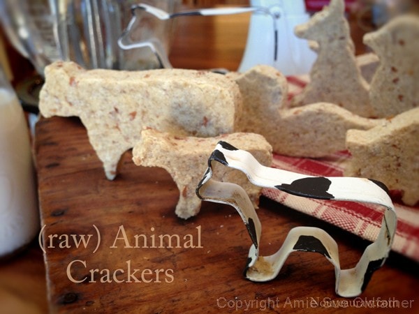 raw vegan gluten free Animal Crackers displayed on a wooden board