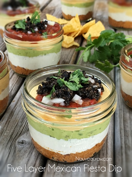 raw vegan Five Layer Mexican Fiesta Dip served in individual mason jars